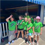 Camp Venture participants with their couselor in front of a carosel