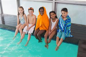 Boys And Girls With Their Feet In The Pool