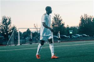 A Man Walking On The Field During Soccer Game